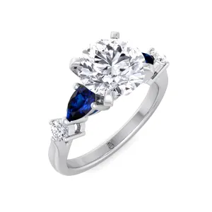 Monaca - Round Cut Engagement Ring with Blue Sapphire Pear Shape Sidestones